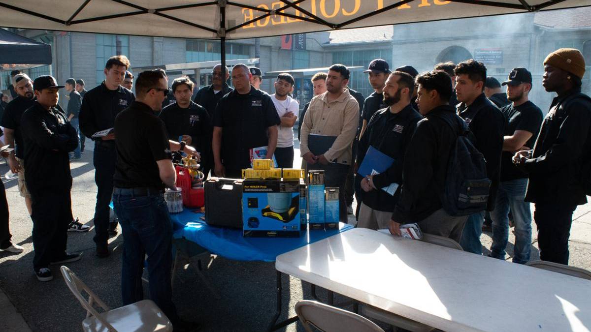 HVAC Students listening to information in front of a table