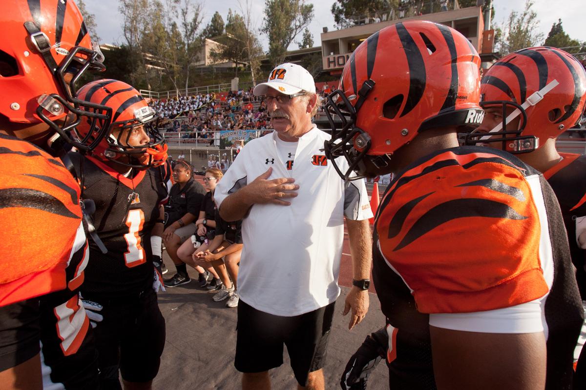 Coach huddled with football team 