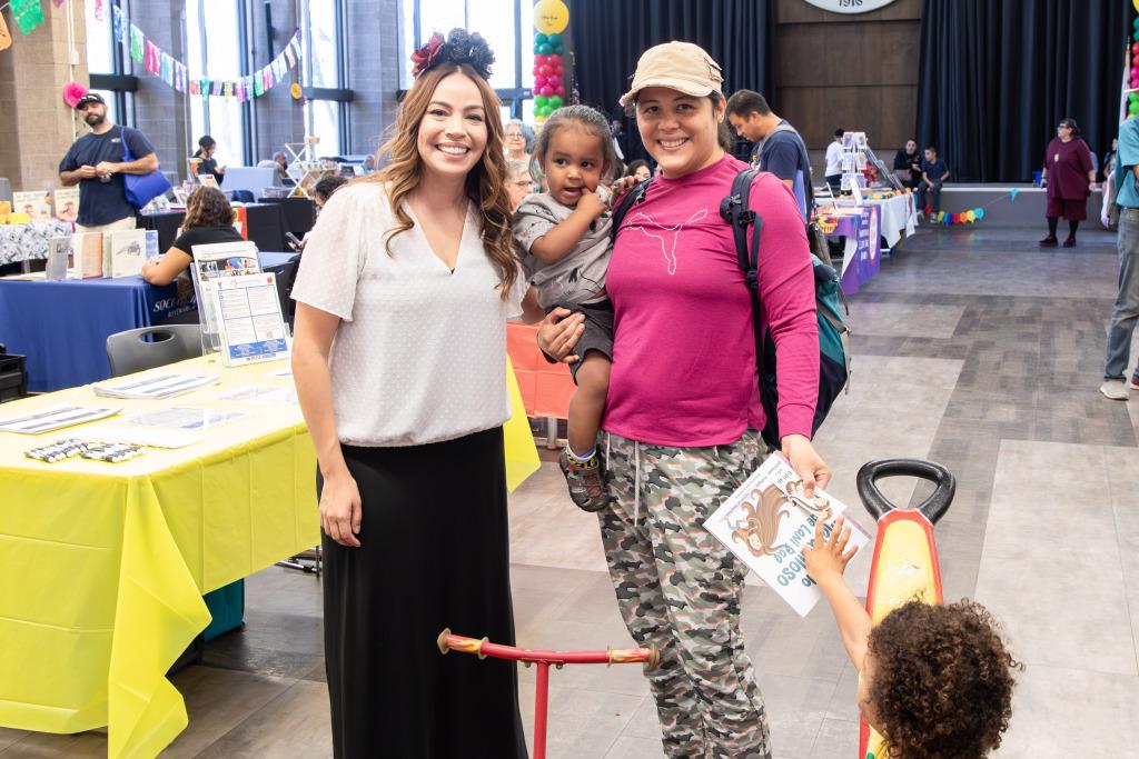 RCCD cosmetology alumna and author with community members