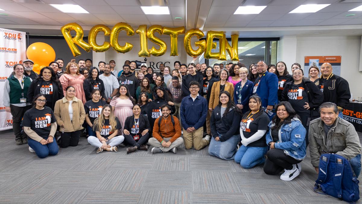 Group photo of those in attendence at mixer- first generation balloons behind them