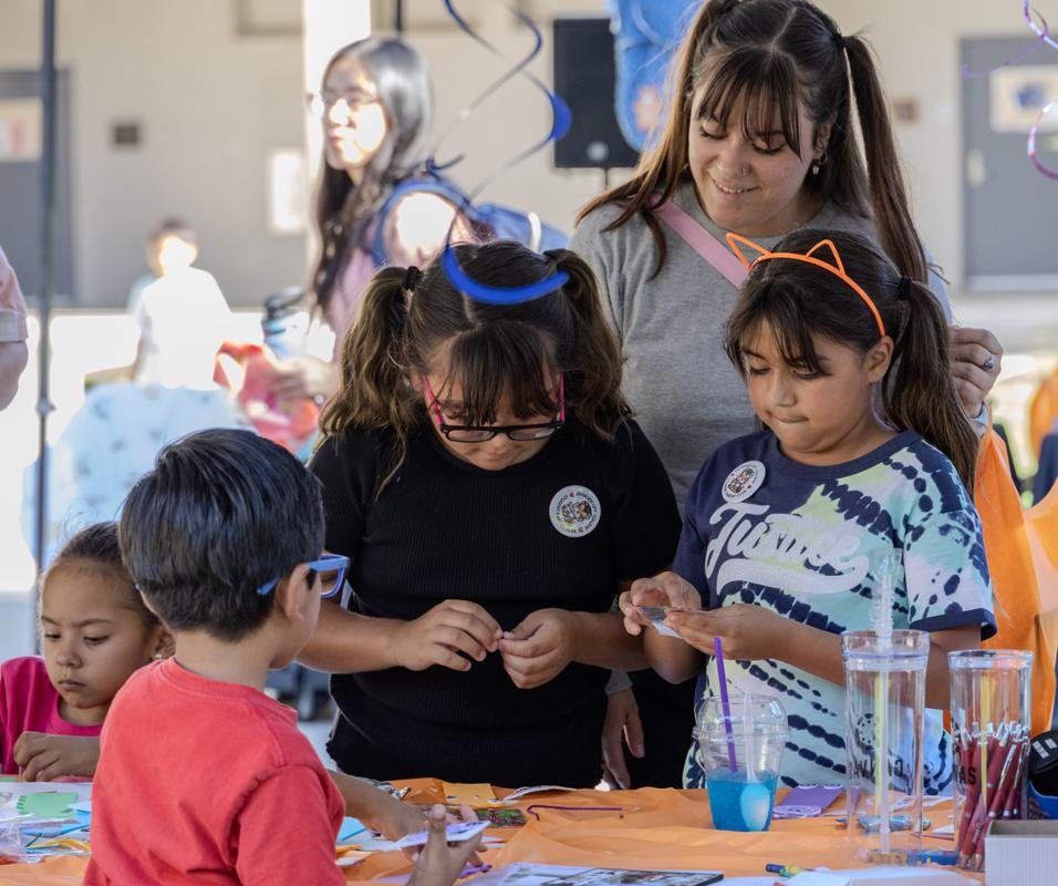 Children enjoying arts and crafts at a table