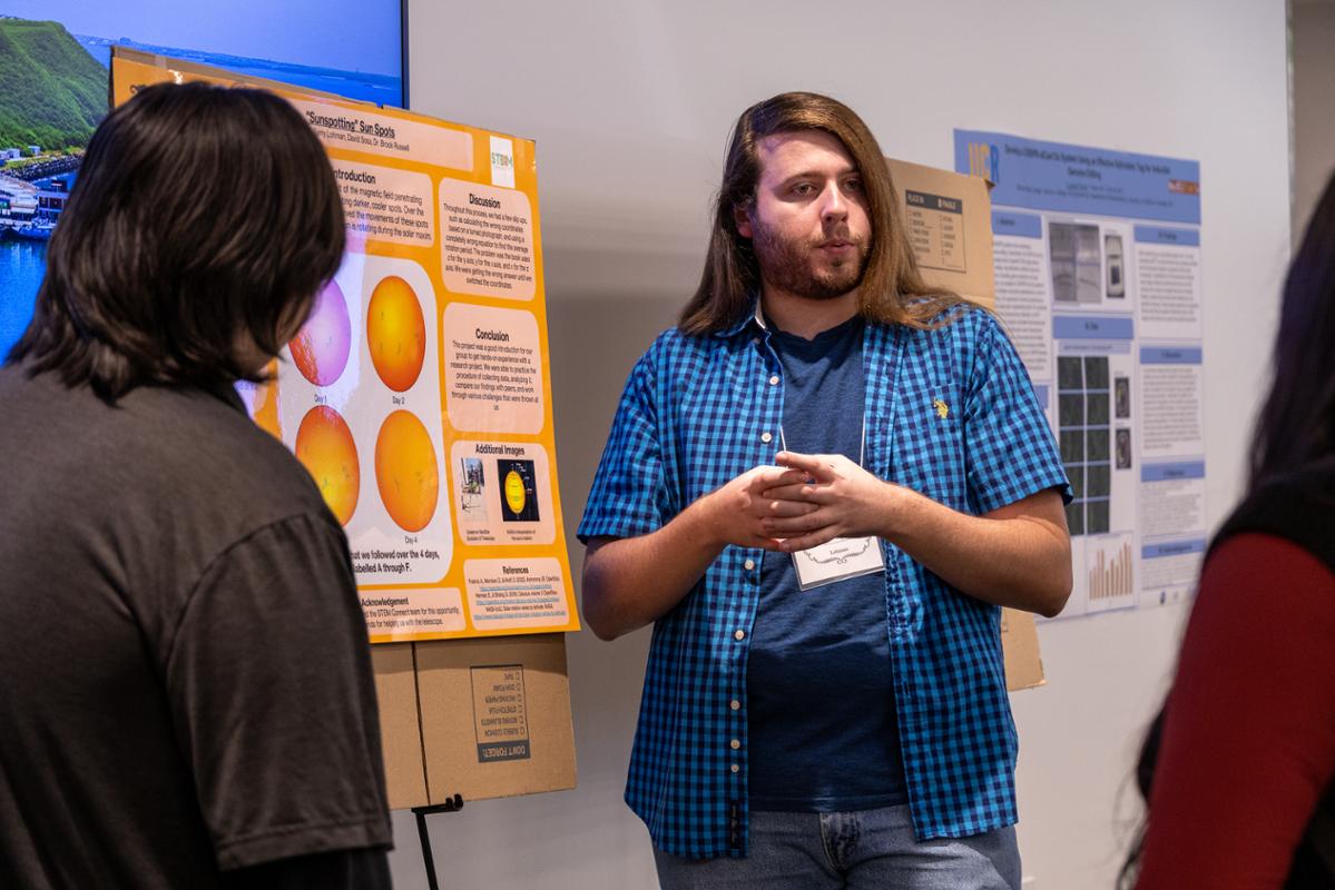 Student Presenting a poster of their research