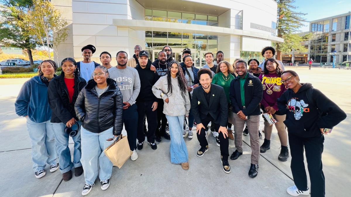 Umoja students in front of a college building