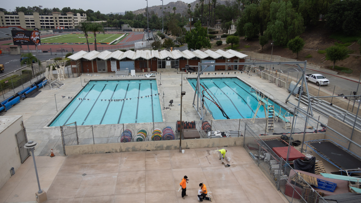 Swimmers and staff at the refurbished Riverside City College pool as aquatics programs resume following facility repairs.