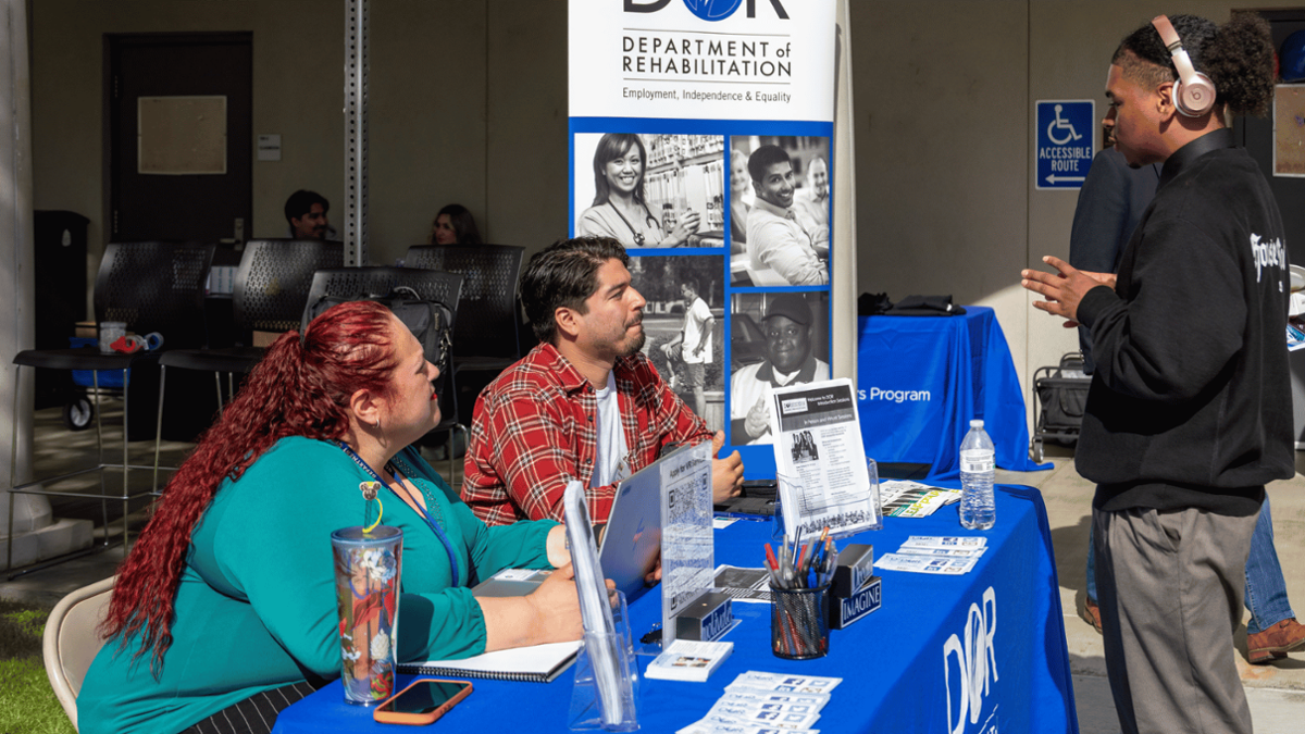 students engaging at vendor table 