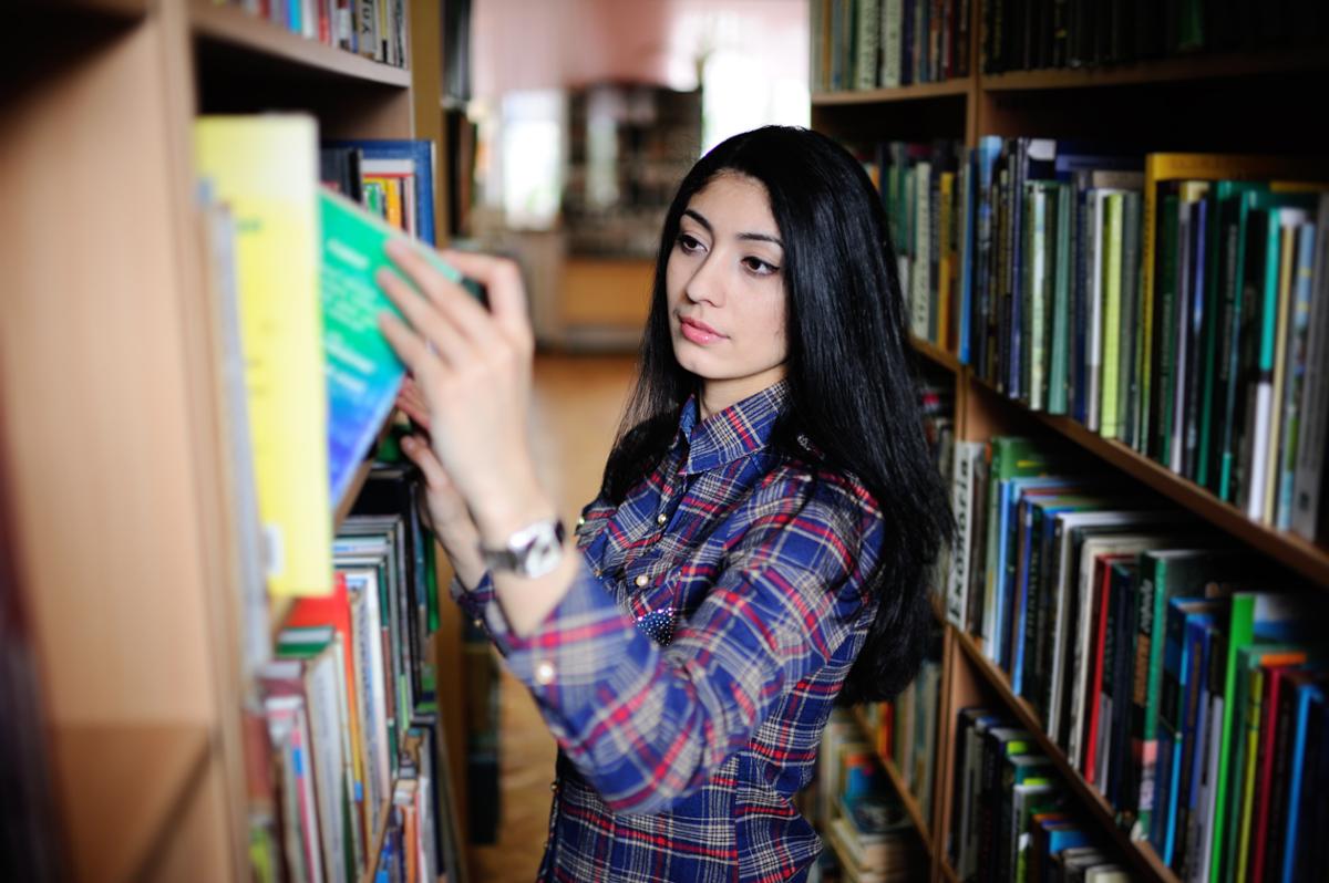 Student looking at books