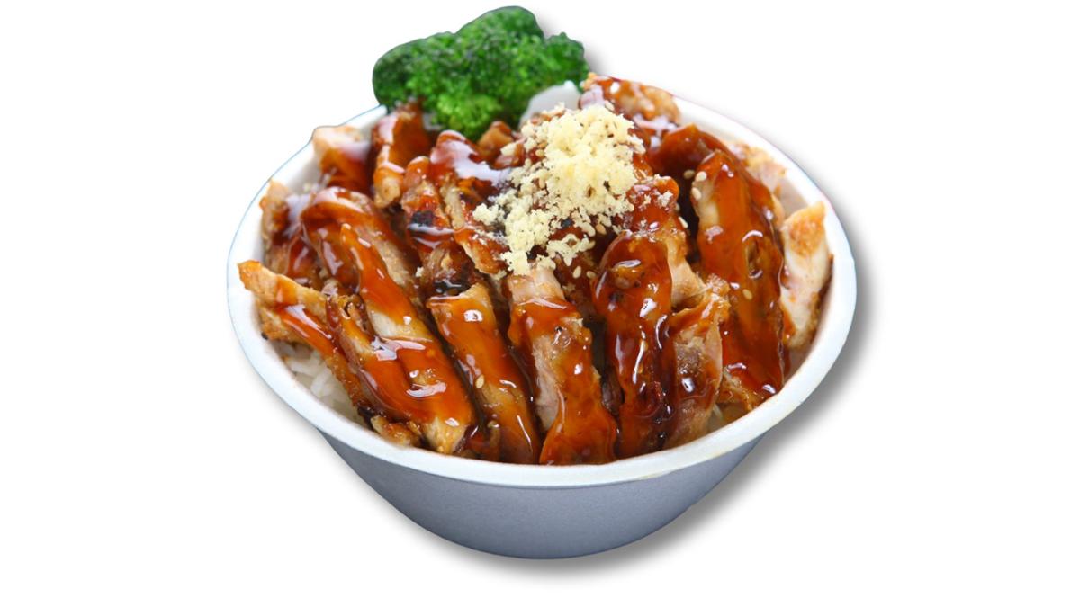 Grilled chicken slices glazed with teriyaki sauce served over white rice, topped with shredded cheese and garnished with a broccoli floret in a white bowl.